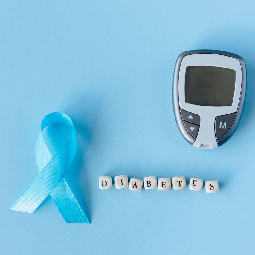 service-1-1 Blue ribbon and glucose meter on blue background highlighting diabetes awareness.